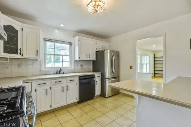 a kitchen with stainless steel appliances granite countertop a sink and cabinets