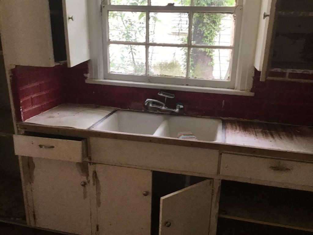 1847 Cook Street Shreveport, LA 71101 - Photo 18 of 38 a kitchen with a sink and a window