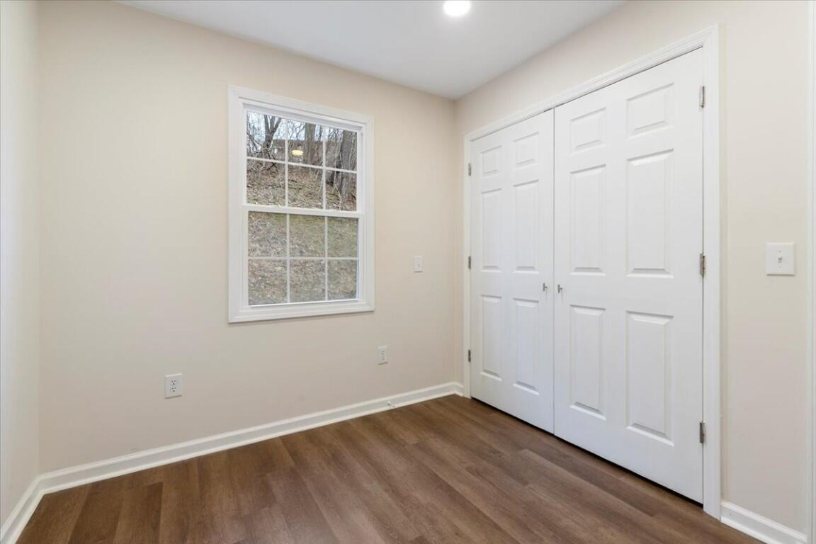 138 Pierce Avenue Pulaski, VA 24301 - Photo 22 of 40 an empty room with wooden floor and windows