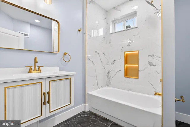 a bathroom with a sink a bathtub and a mirror