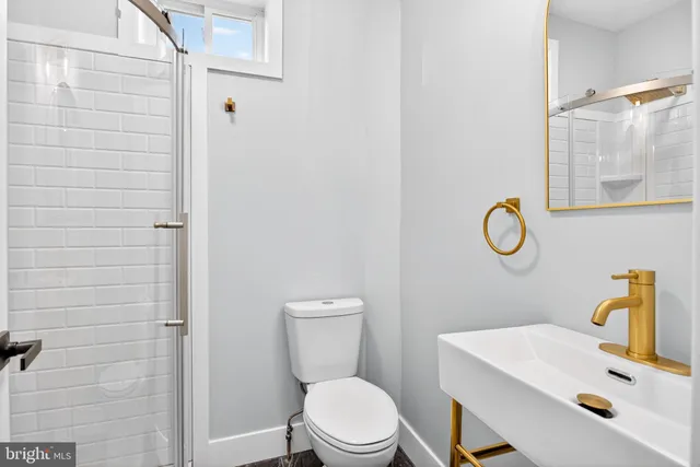 a white toilet sitting next to a bathroom sink