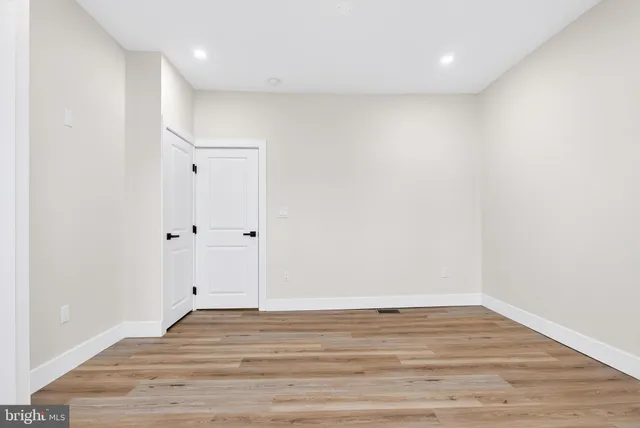 a view of room with wooden floor