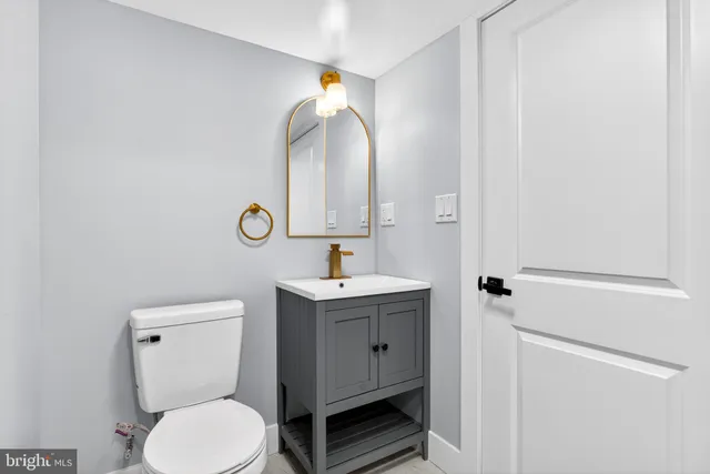 a bathroom with a toilet sink and mirror