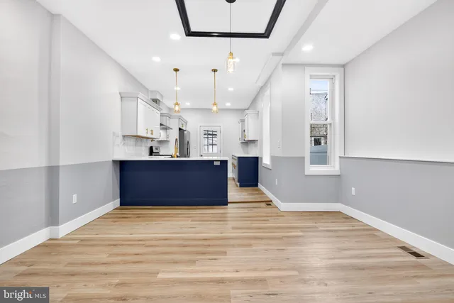 a view of kitchen and hall with wooden floor