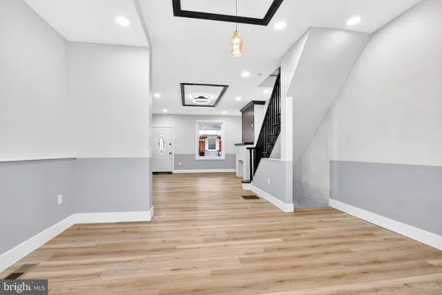 a view of entryway and hall with wooden floor