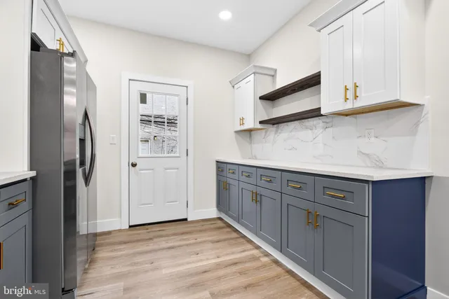 a kitchen with stainless steel appliances granite countertop a refrigerator and a microwave
