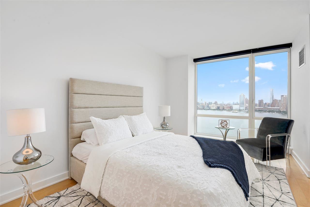 2 2nd Street, Unit 2803 Jersey City, NJ 07302 - Photo 12 of 28 a bedroom with a bed and large window