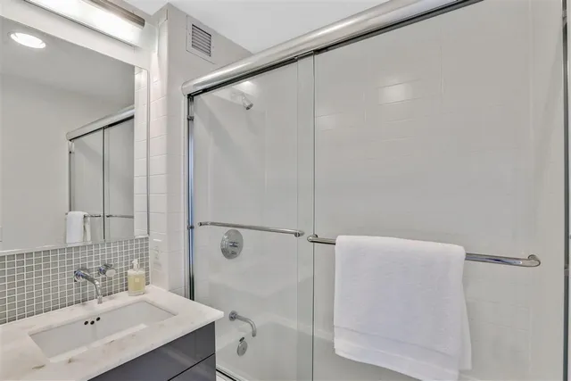 a bathroom with a shower and a sink