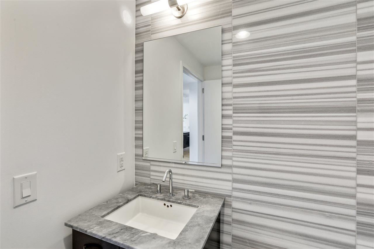2 2nd Street, Unit 2803 Jersey City, NJ 07302 - Photo 16 of 28 a bathroom with a sink and a mirror