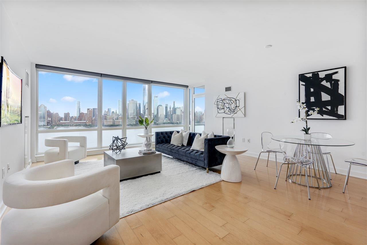 2 2nd Street, Unit 2803 Jersey City, NJ 07302 - Photo 2 of 28 a living room with furniture and a large window