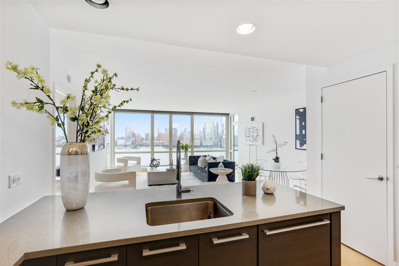 2 2nd Street, Unit 2803 Jersey City, NJ 07302 - Photo 7 of 28 a kitchen with a sink a counter and a potted plant