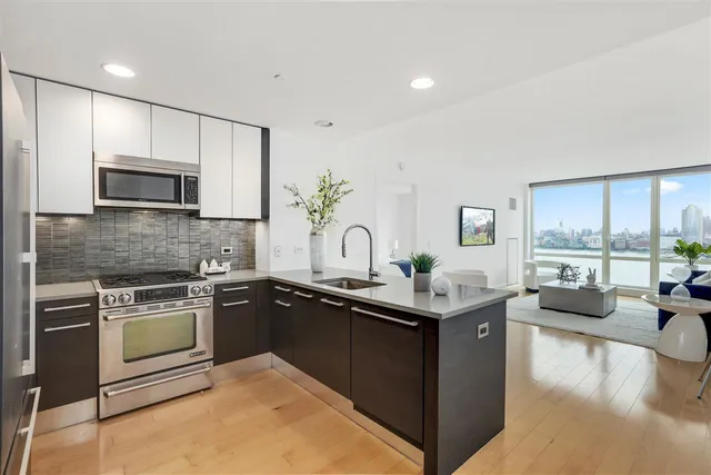 a kitchen with stainless steel appliances granite countertop sink stove and cabinets