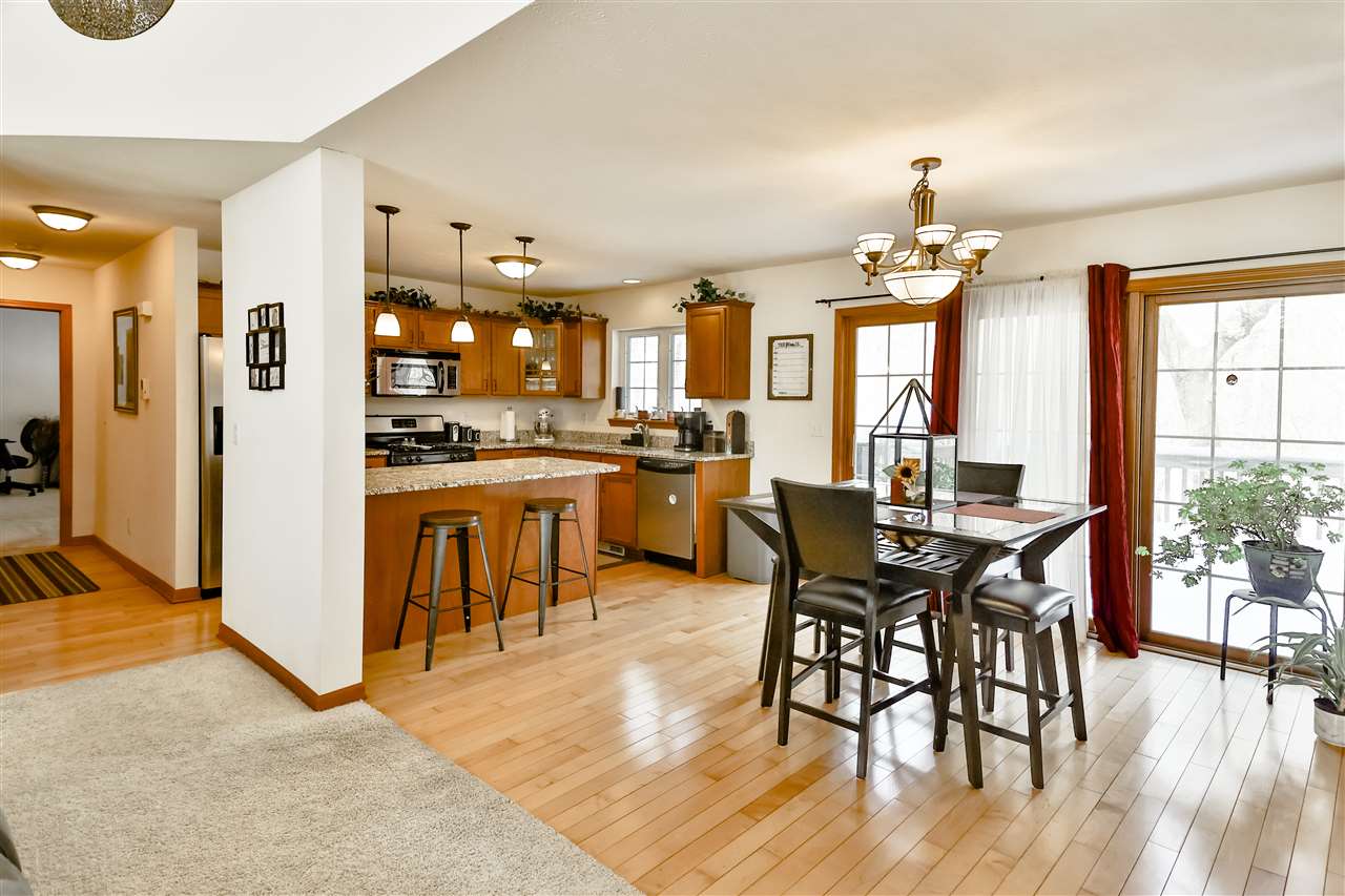 312 Rochester Road Northeast Poplar Grove, IL 61065 - Photo 10 of 28 a view of a dining room with furniture and wooden floor