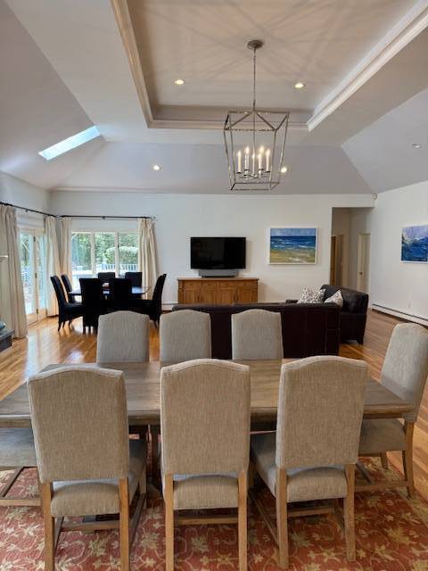 3 Stone Lane Quogue, NY 11959 - Photo 15 of 35 a view of a dining room with furniture a chandelier and wooden floor