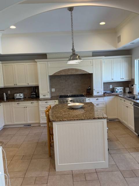 3 Stone Lane Quogue, NY 11959 - Photo 28 of 35 a kitchen with stainless steel appliances granite countertop a stove and a sink