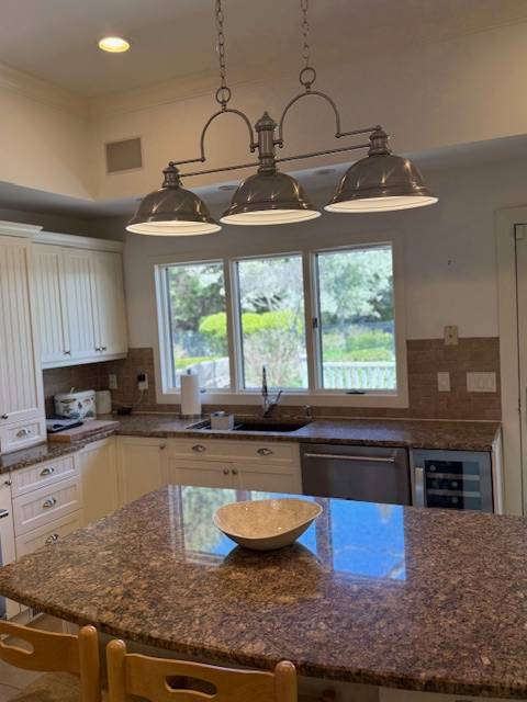 3 Stone Lane Quogue, NY 11959 - Photo 30 of 35 a kitchen with kitchen island granite countertop a stove a sink and a granite counter tops
