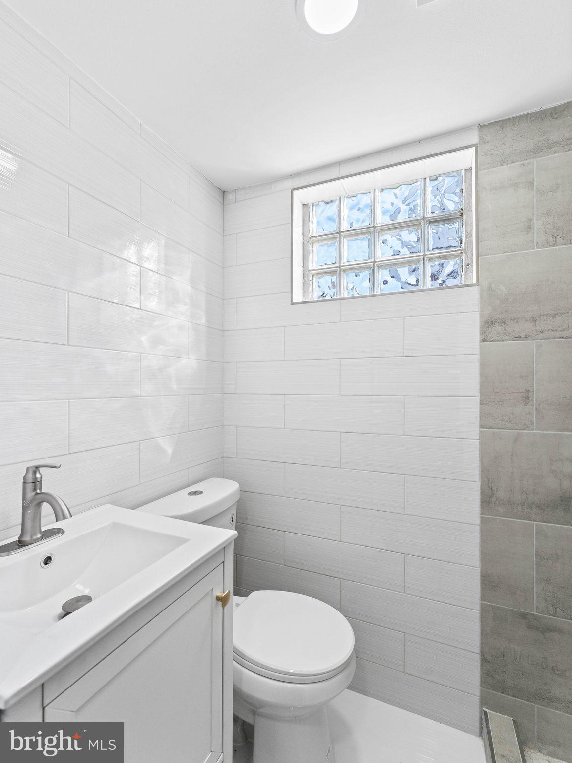 1152 Morefield Road Philadelphia, PA 19115 - Photo 27 of 29 a bathroom with a granite countertop toilet a sink and mirror
