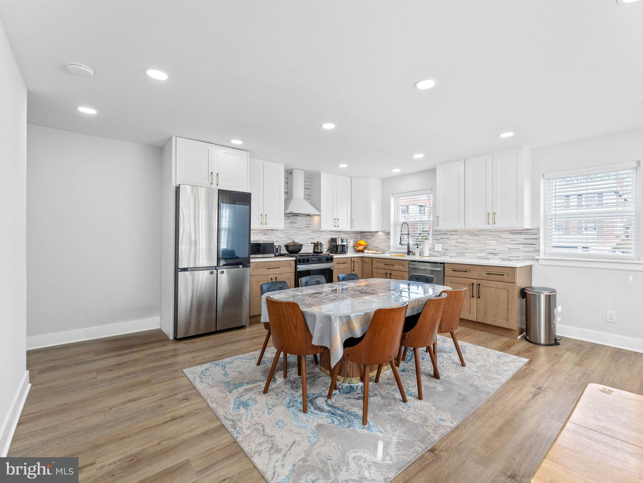1152 Morefield Road Philadelphia, PA 19115 - Photo 3 of 29 a kitchen with refrigerator a sink and chairs
