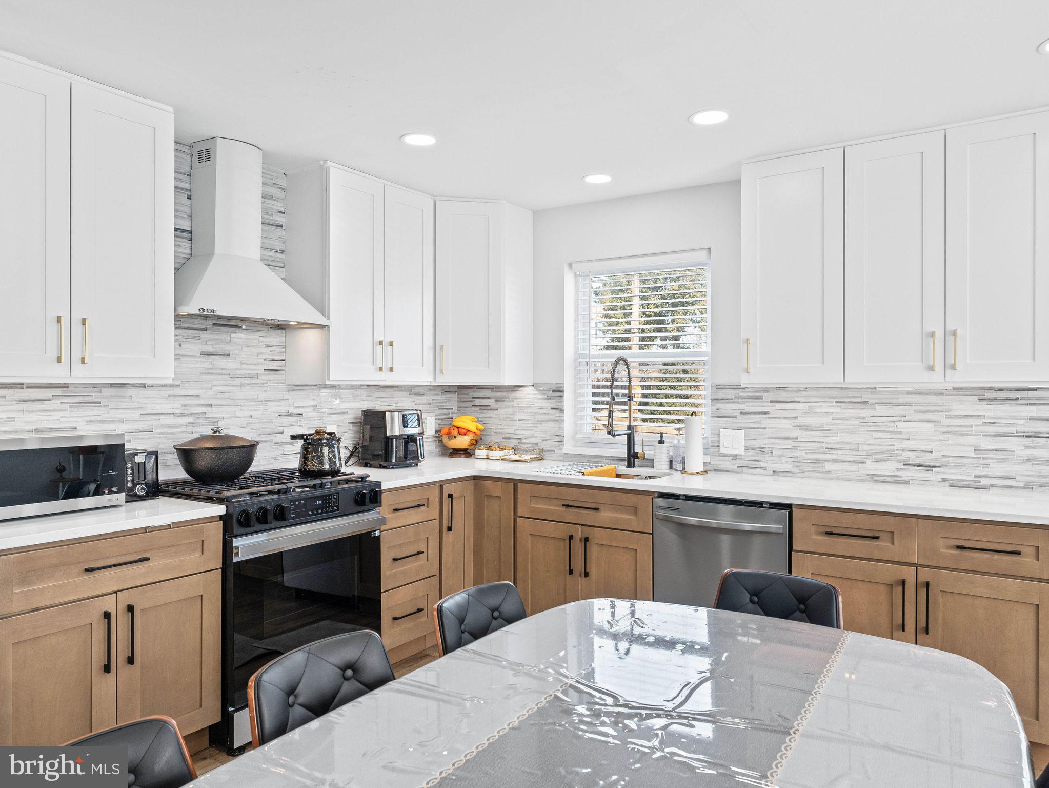 1152 Morefield Road Philadelphia, PA 19115 - Photo 6 of 29 a kitchen with a sink stove and cabinets