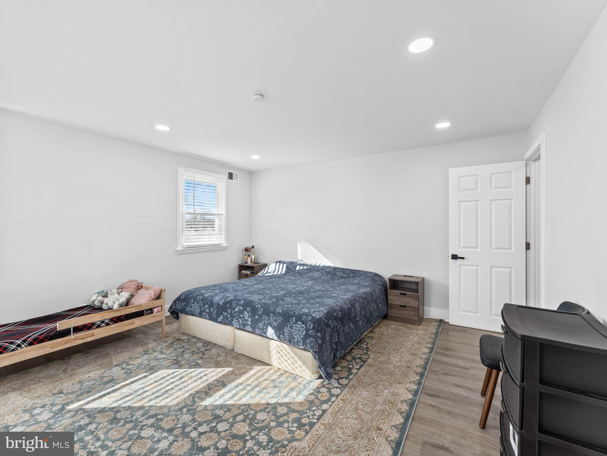 1152 Morefield Road Philadelphia, PA 19115 - Photo 8 of 29 a bedroom with a bed and wooden floor