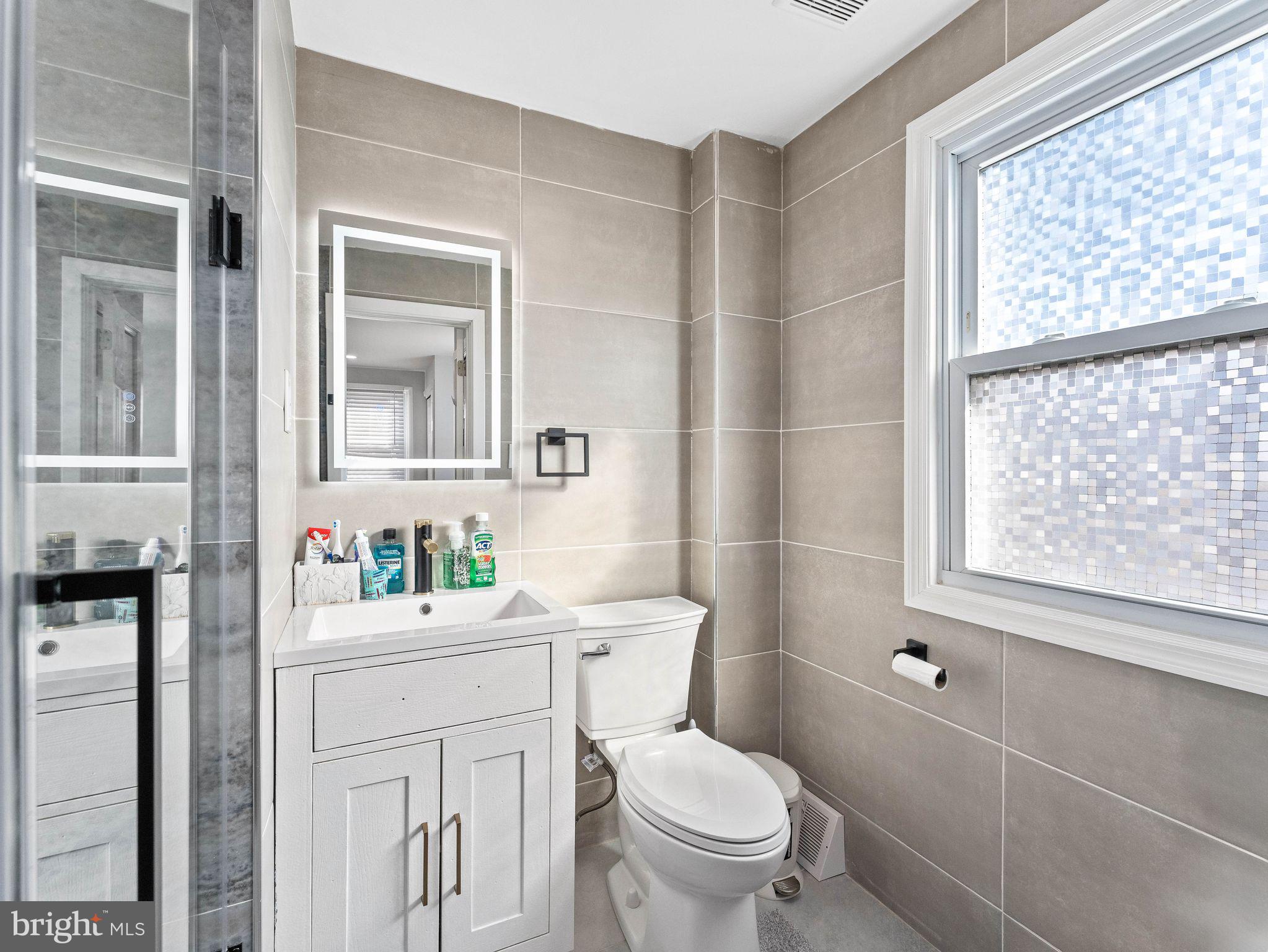1152 Morefield Road Philadelphia, PA 19115 - Photo 9 of 29 a bathroom with a sink toilet and window