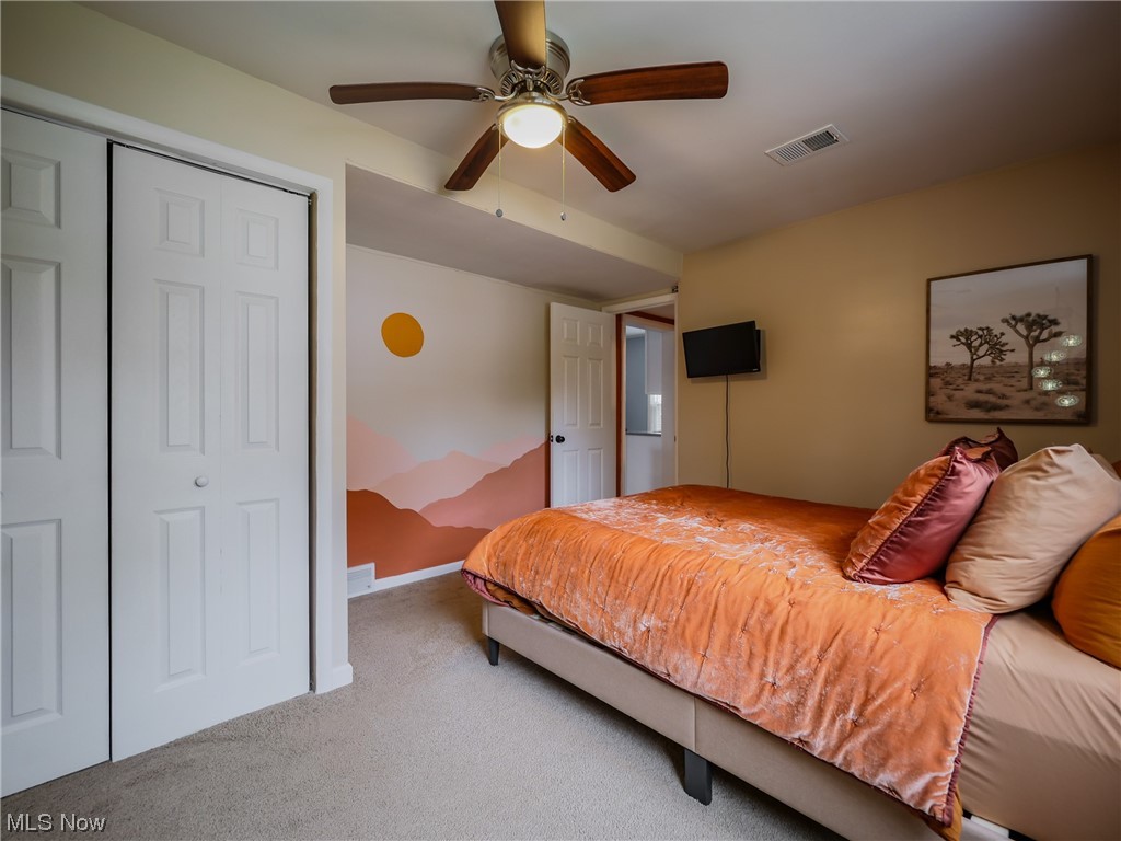 1240 Churchill Road Lyndhurst, OH 44124 - Photo 12 of 30 Bedroom featuring ceiling fan, a closet, and light colored carpet
