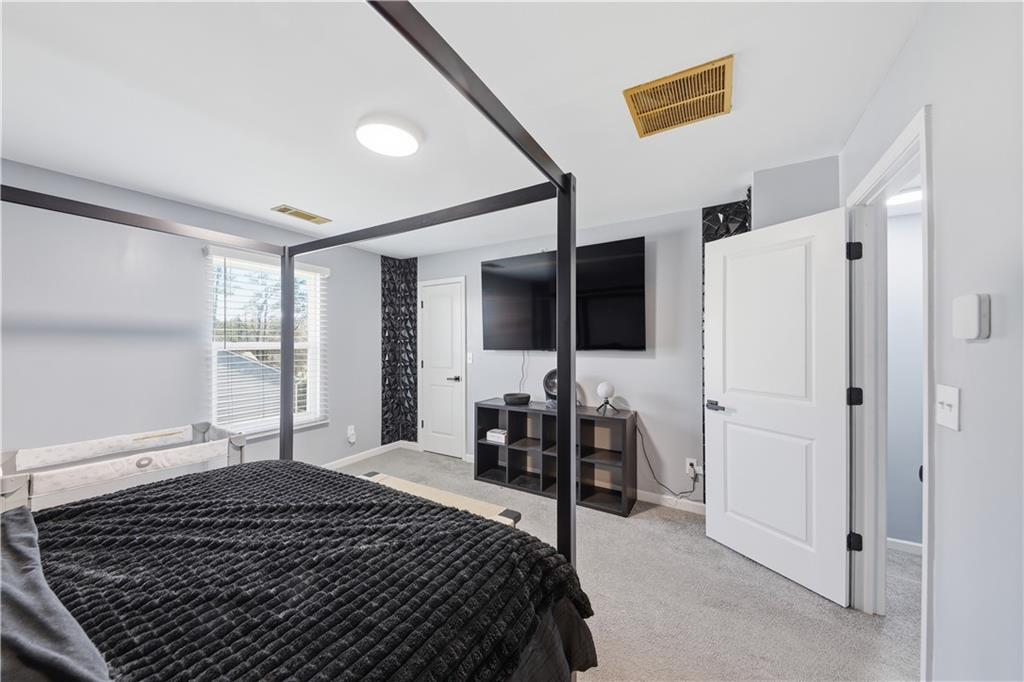 2166 Braxton Road Southwest Atlanta, GA 30331 - Photo 16 of 19 a bedroom with a bed and a large window