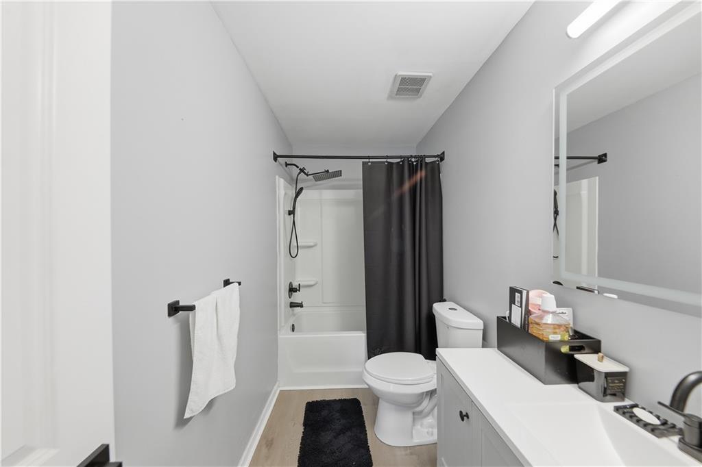 2166 Braxton Road Southwest Atlanta, GA 30331 - Photo 17 of 19 a white toilet sitting next to a bathroom sink