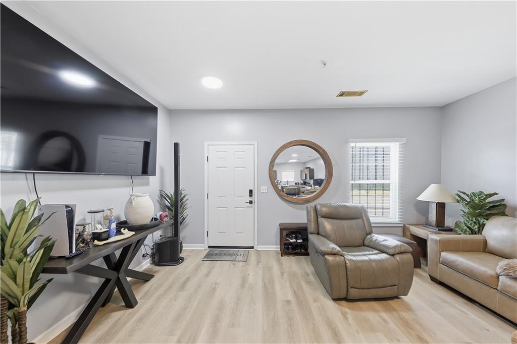 2166 Braxton Road Southwest Atlanta, GA 30331 - Photo 2 of 19 a living room with furniture a window and a clock