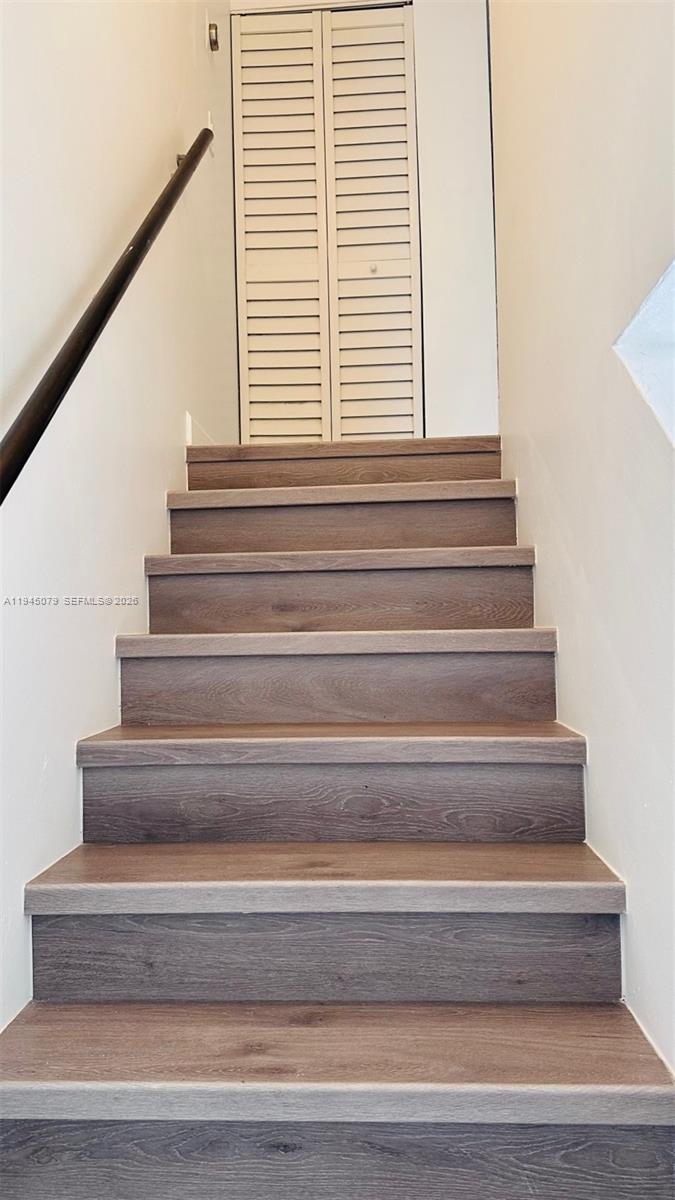 8240 Southwest 149th Court, Unit 7205 Miami, FL 33193 - Photo 11 of 14 a view of staircase with white walls