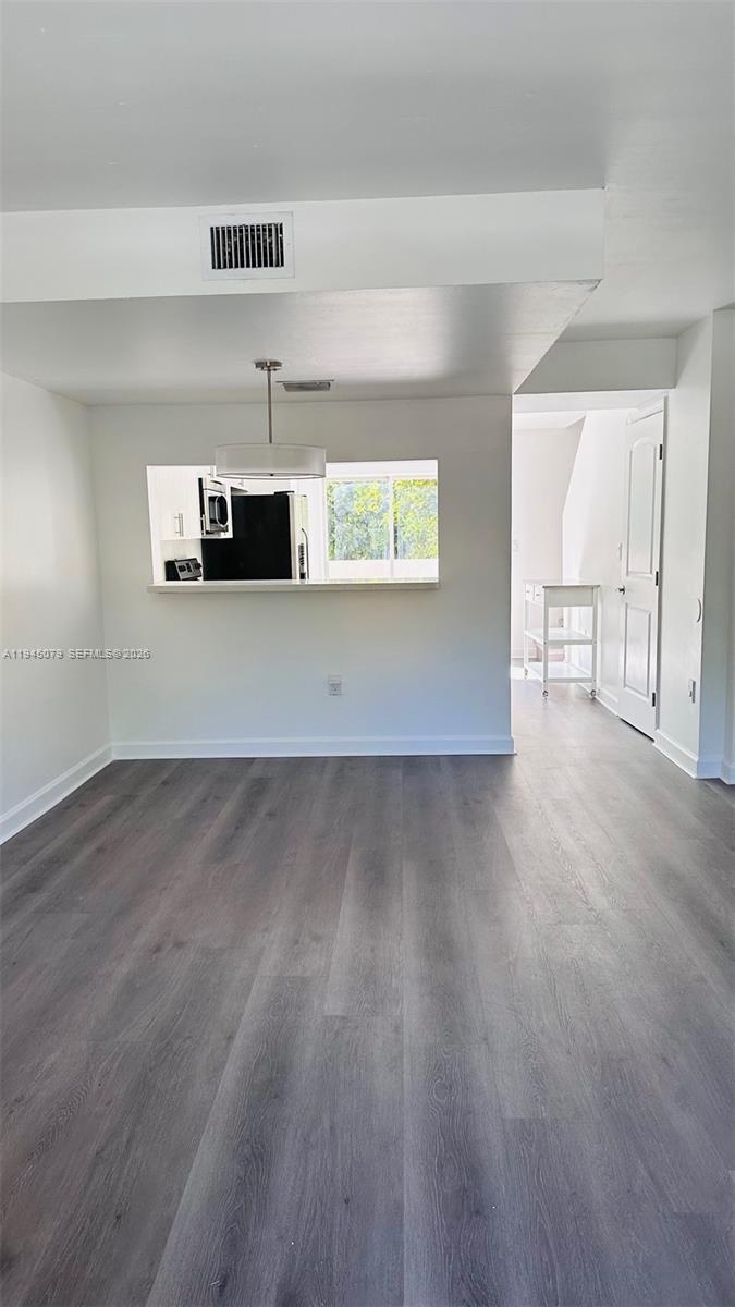 8240 Southwest 149th Court, Unit 7205 Miami, FL 33193 - Photo 4 of 14 a view of a room with wooden floor and window