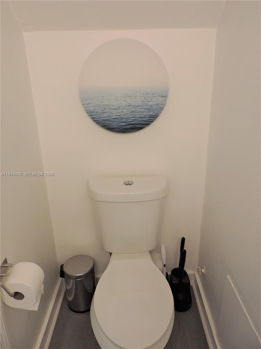 8240 Southwest 149th Court, Unit 7205 Miami, FL 33193 - Photo 5 of 14 a bathroom with a toilet and a sink