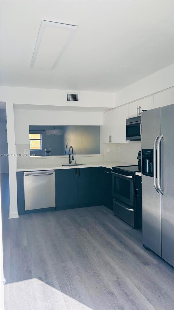 8240 Southwest 149th Court, Unit 7205 Miami, FL 33193 - Photo 9 of 14 a kitchen with stainless steel appliances a refrigerator and a sink