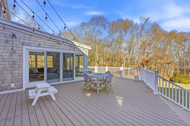 a view of a chairs and table in patio with a yard