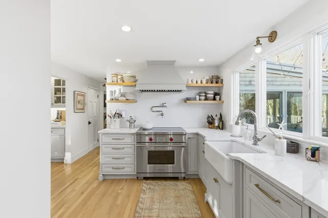 a kitchen with stainless steel appliances granite countertop a stove and a sink