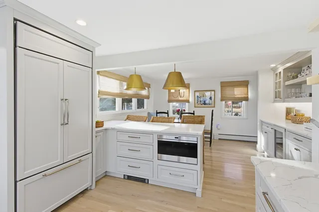 a view of kitchen with stainless steel appliances granite countertop a refrigerator and a stove