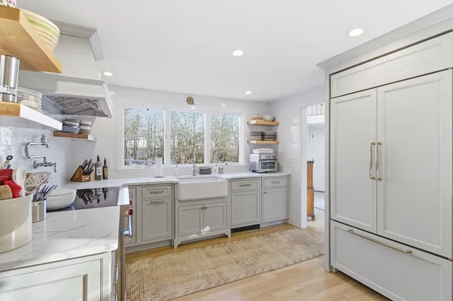 a large bathroom with a large mirror vanity and shower