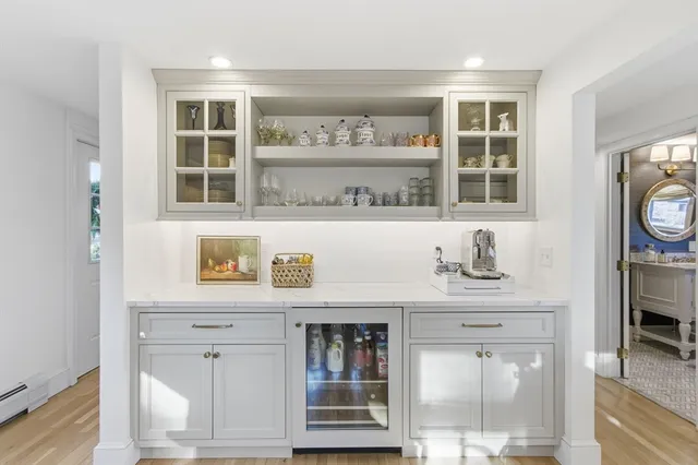 a dining room with furniture a chandelier and wooden floor