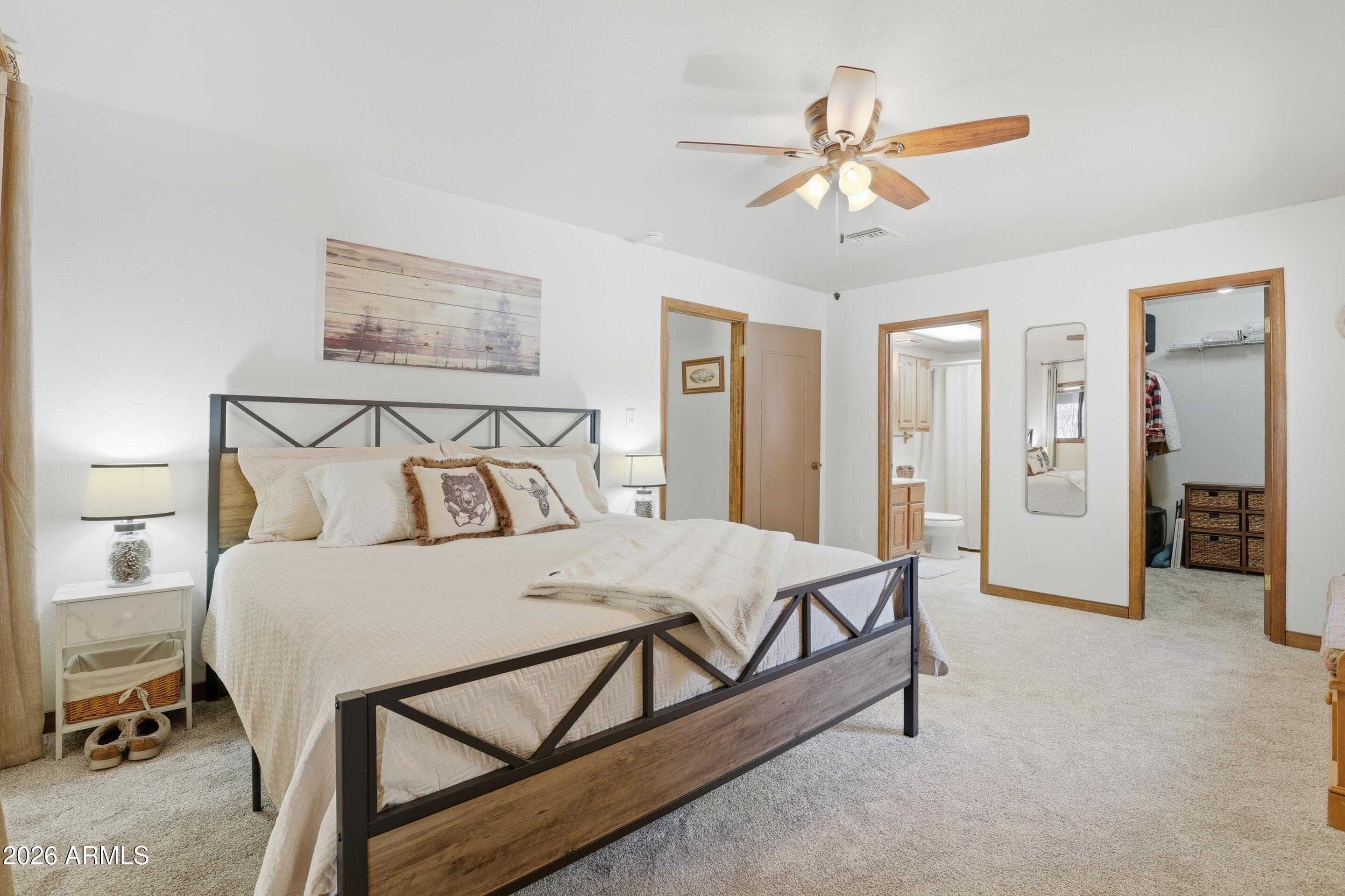 6740 Ridge Road Pine, AZ 85544 - Photo 12 of 35 a bedroom with a bed and a chandelier
