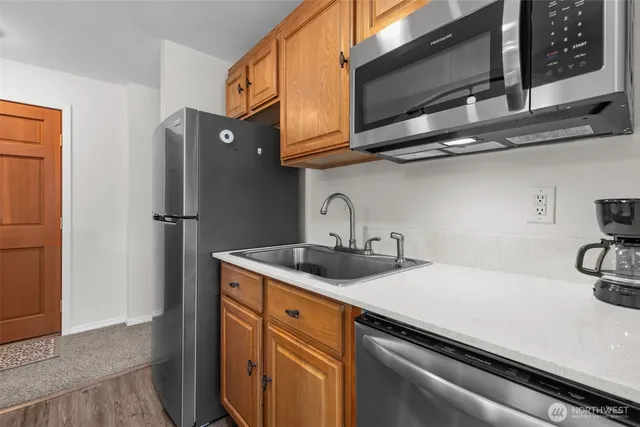 a kitchen with stainless steel appliances a sink and cabinets