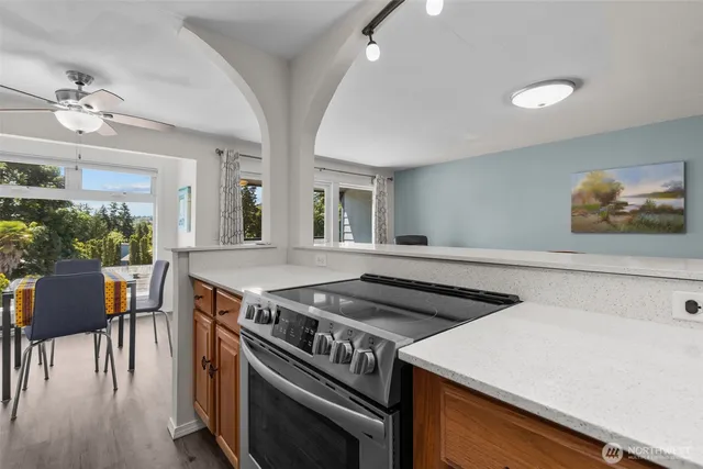 a kitchen with a stove and a table chair