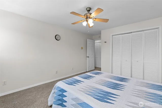 a view of a bedroom with a bed and a chandelier