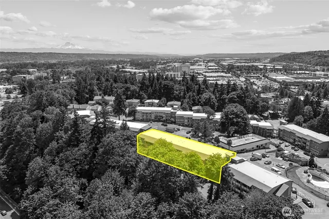 an aerial view of a house with a garden and lake view