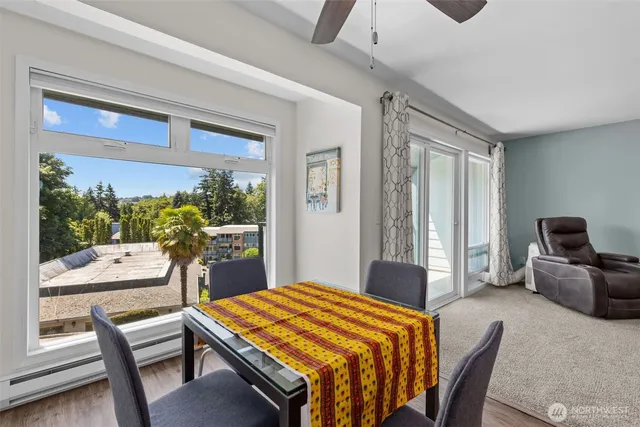 a bedroom with a bed and large windows