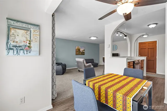 a hall with a dining table and chairs with wooden floor