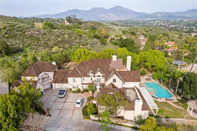 an aerial view of residential house with an outdoor space and seating