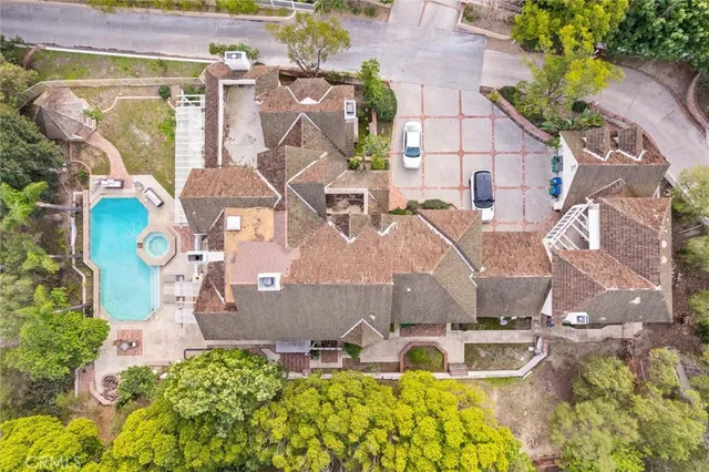 an aerial view of a house with a swimming pool