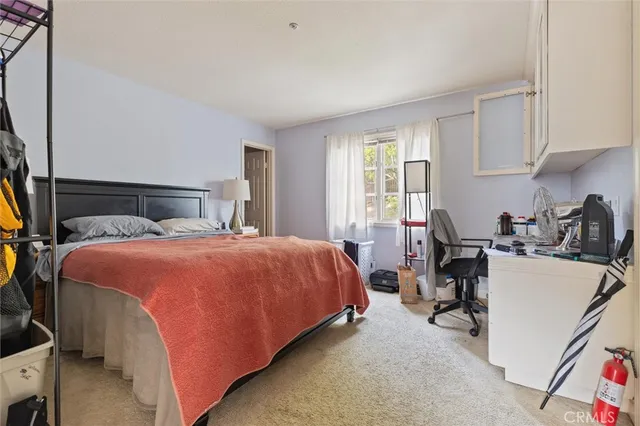 a bedroom with a bed and a book shelf