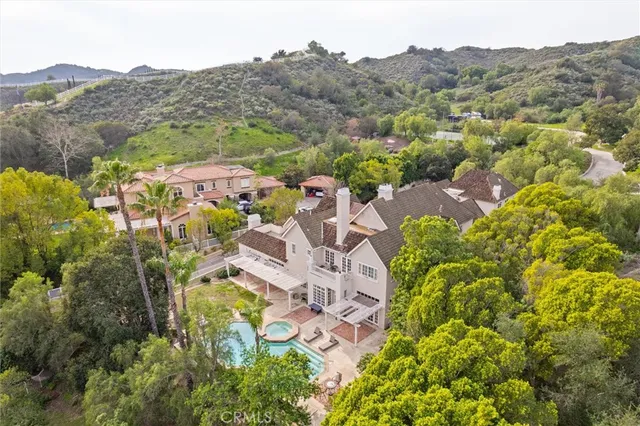 an aerial view of residential house with an outdoor space and seating