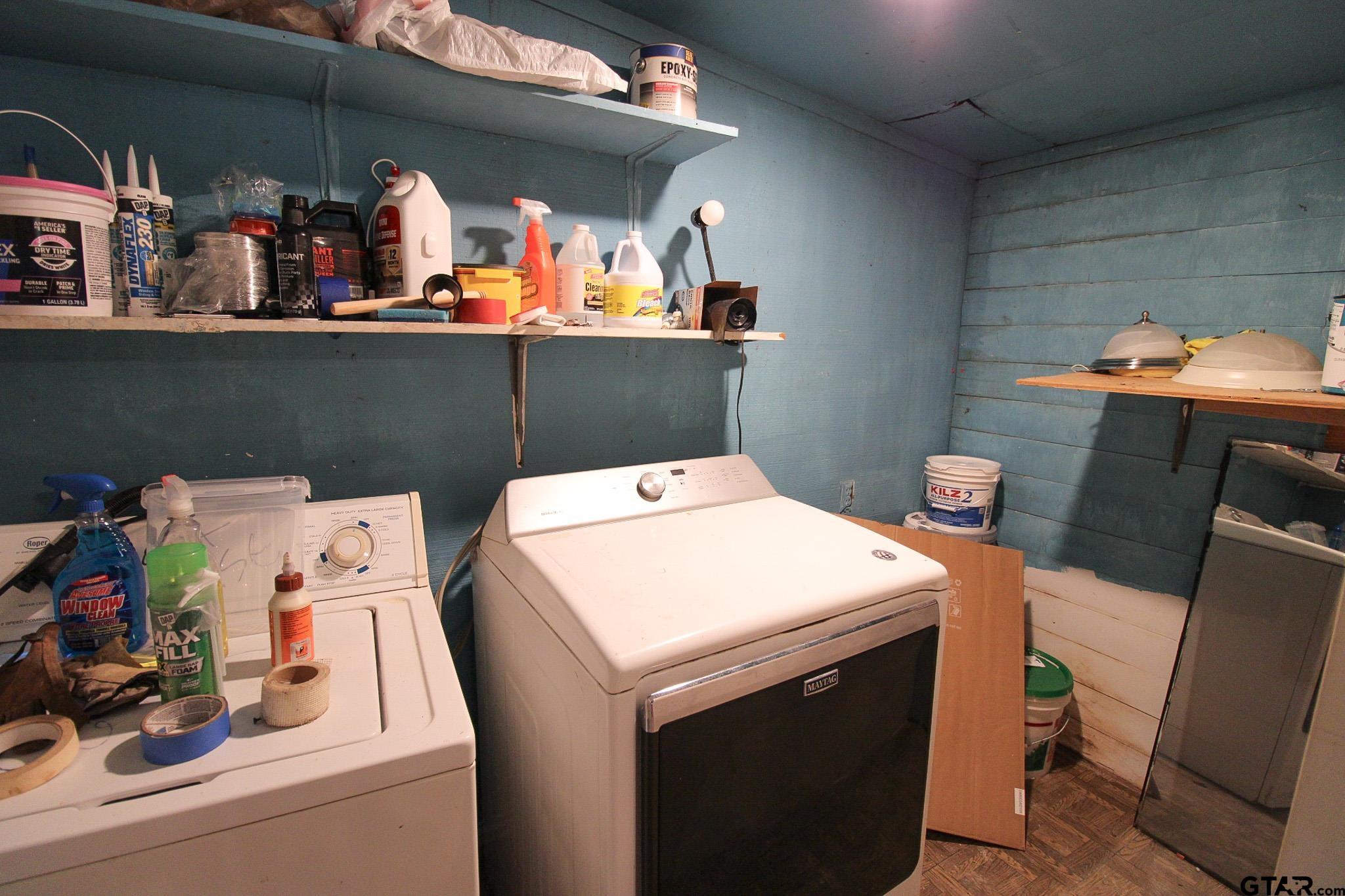 407 Pace Street Naples, TX 75568 - Photo 24 of 31 a utility room with dryer washer and shoe rack